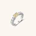Adjustable ring with emerald-cut yellow zirconia center and clear accent stones in geometric platinum-plated setting
