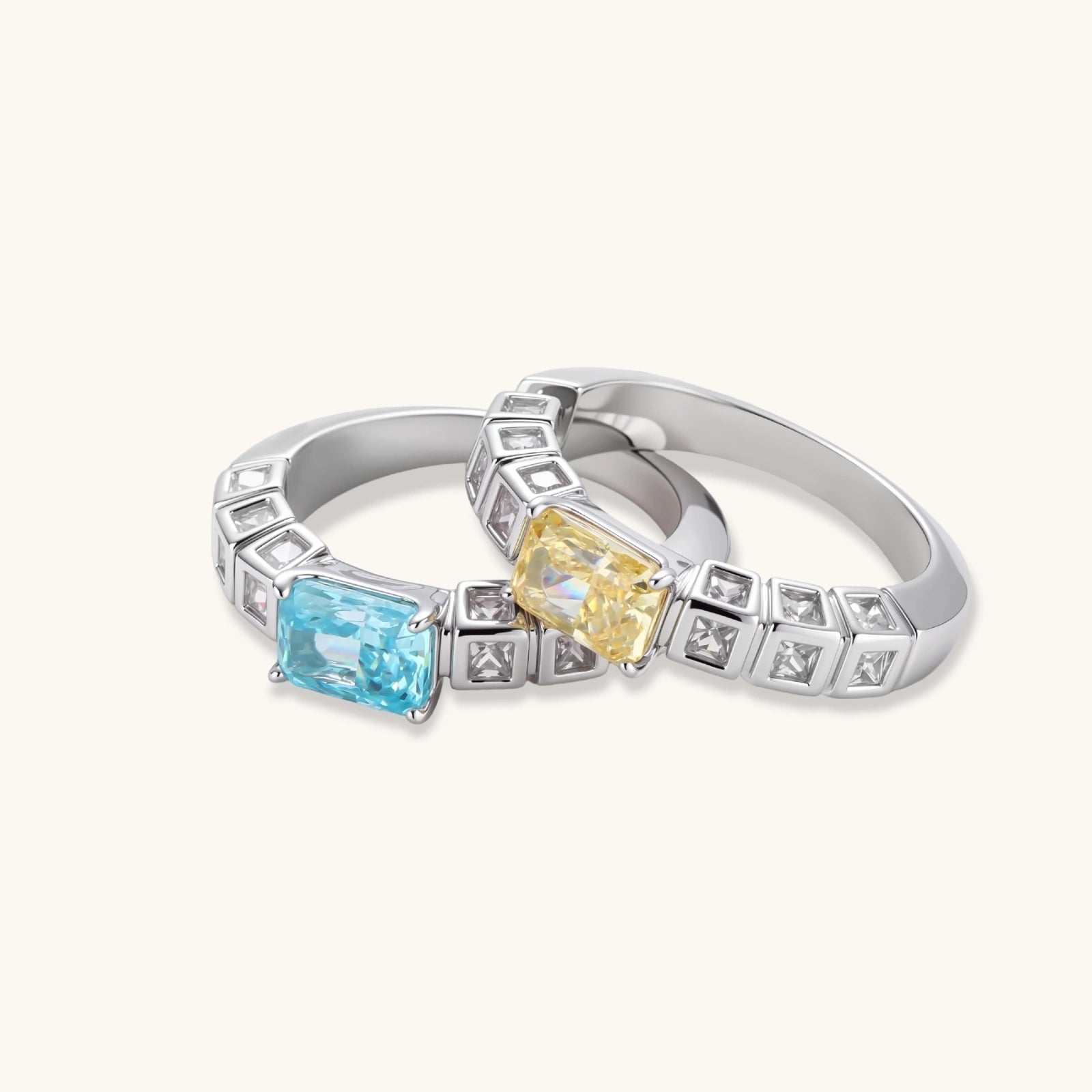Adjustable ring with emerald-cut yellow zirconia center and clear accent stones in geometric platinum-plated setting